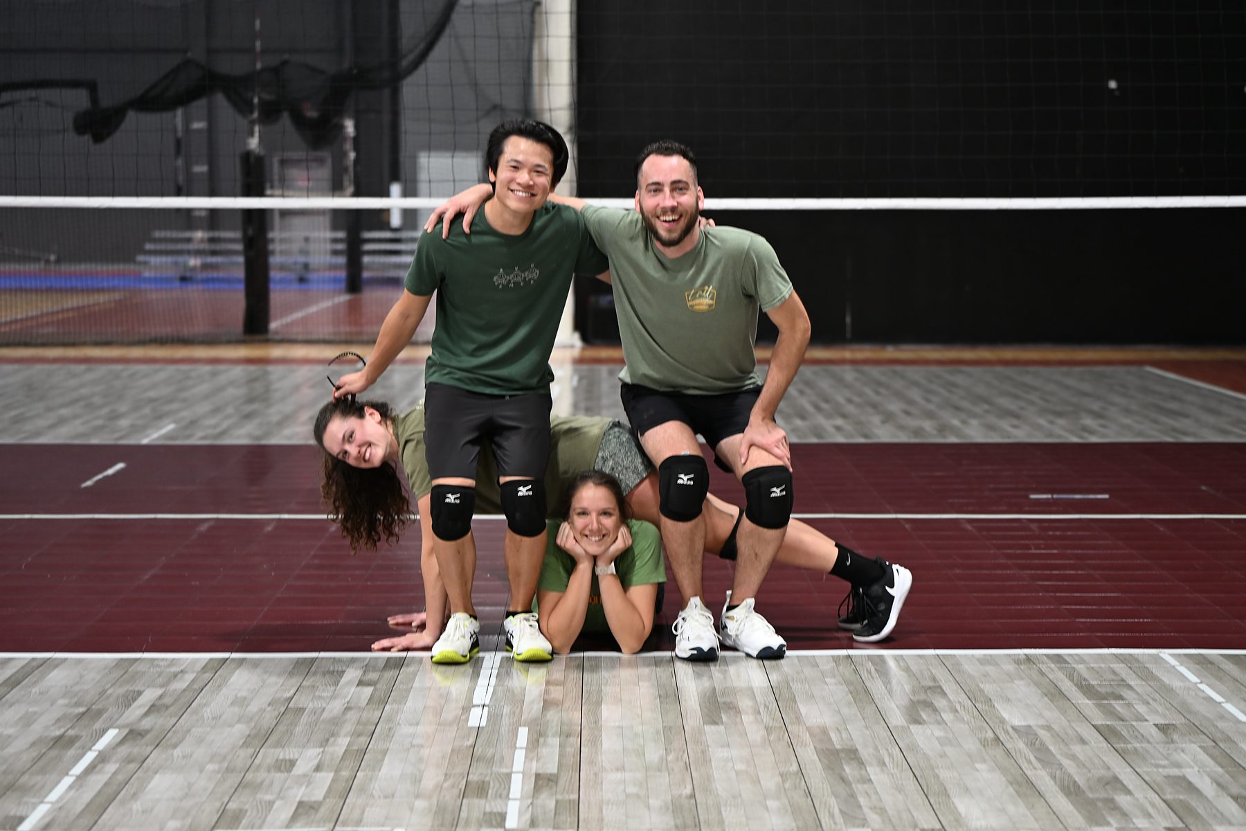 Boomtown co-ed volleyball team posing on court at Boomtown FieldhouseUSA